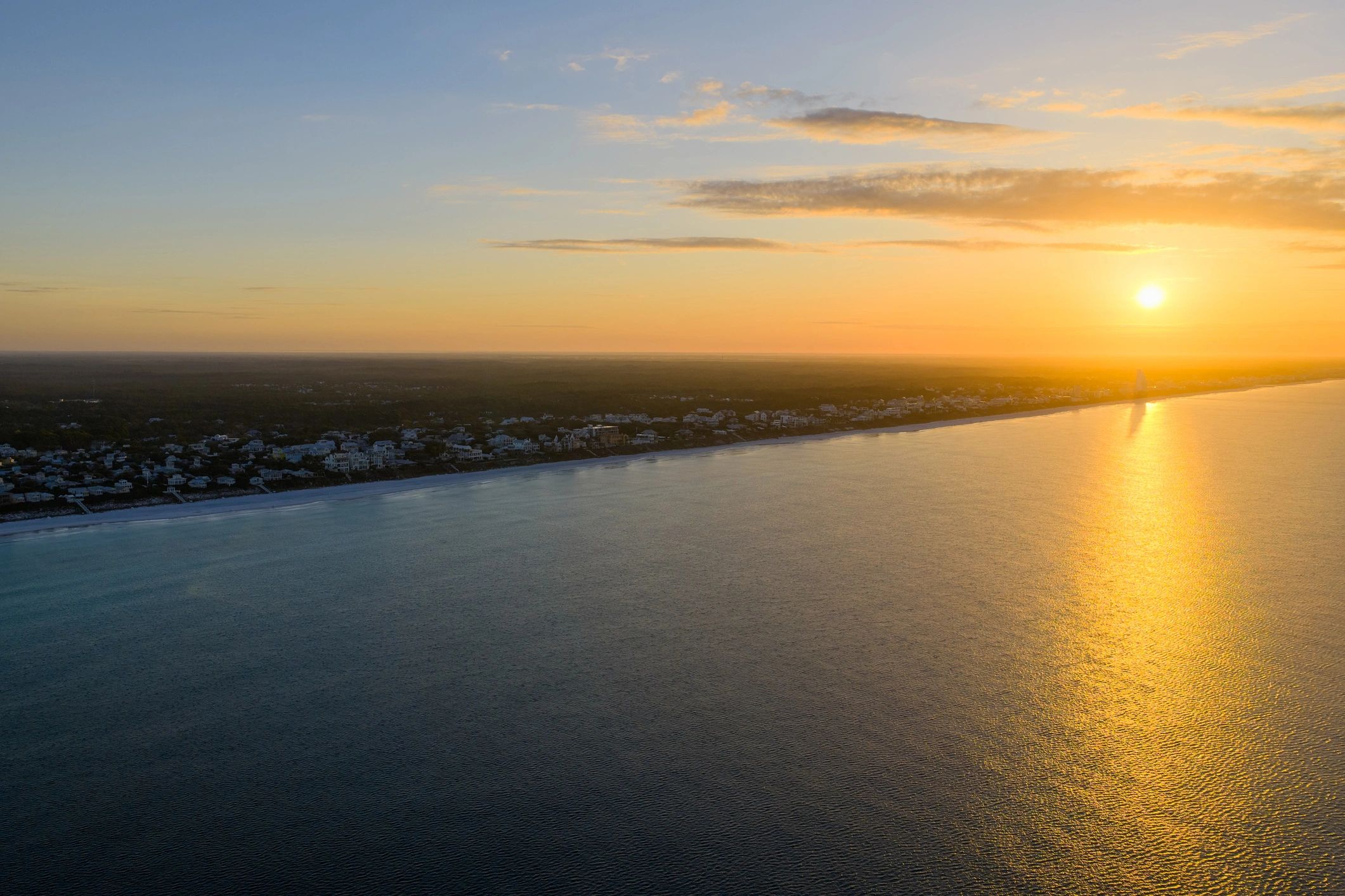 Aerial view of a Florida beachfront community at sunset