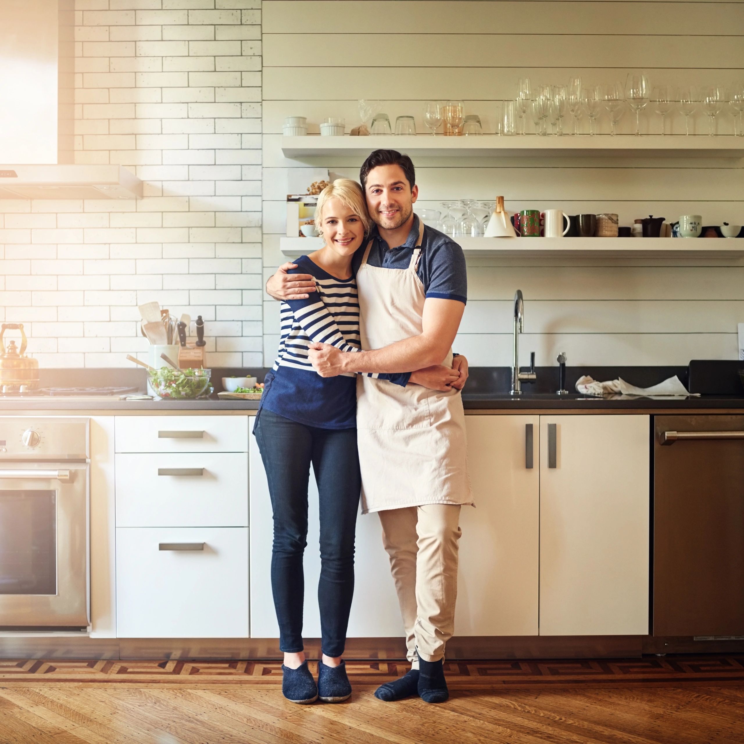Couple standing together in their kitchen